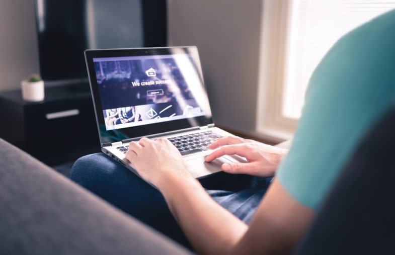 man editing a website on a laptop