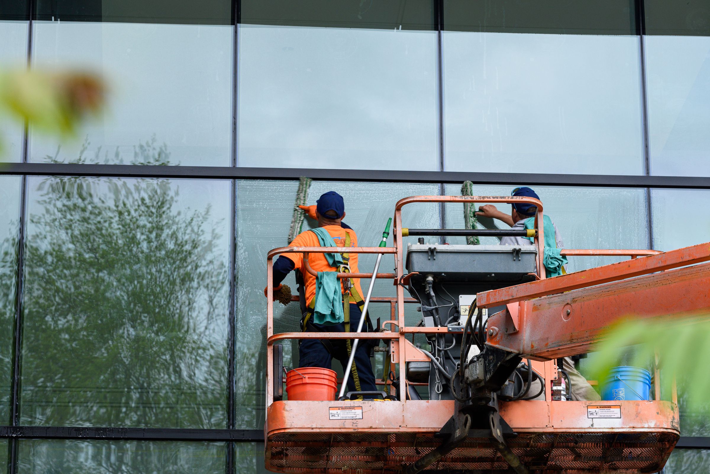 Window cleaners working on a glass building