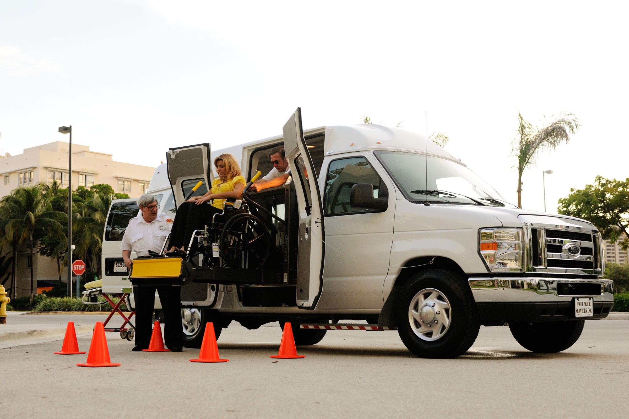 Wheelchair lift boarding a passenger into an accessible van