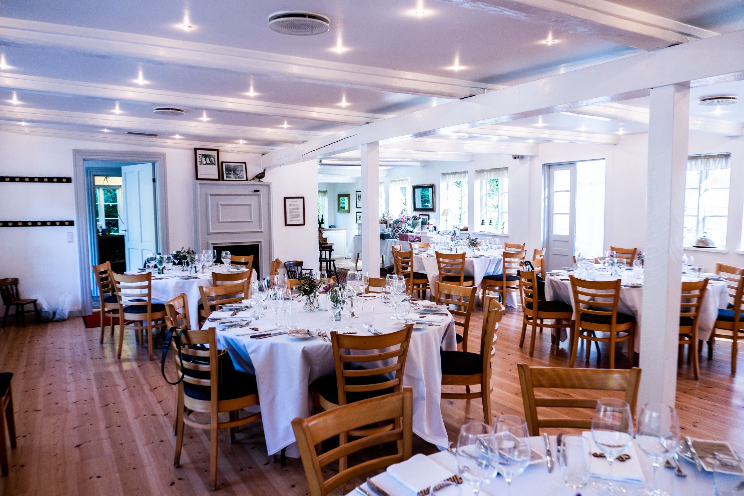 Event room set with round tables, chairs, and linens